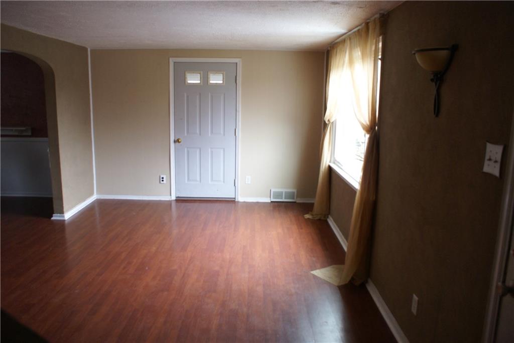 860 Middle Road Pittsburgh, PA 15234 - Photo 12 of 22 nice sized living room with laminate flooring... door leading to den/optional 3rd bedroom
