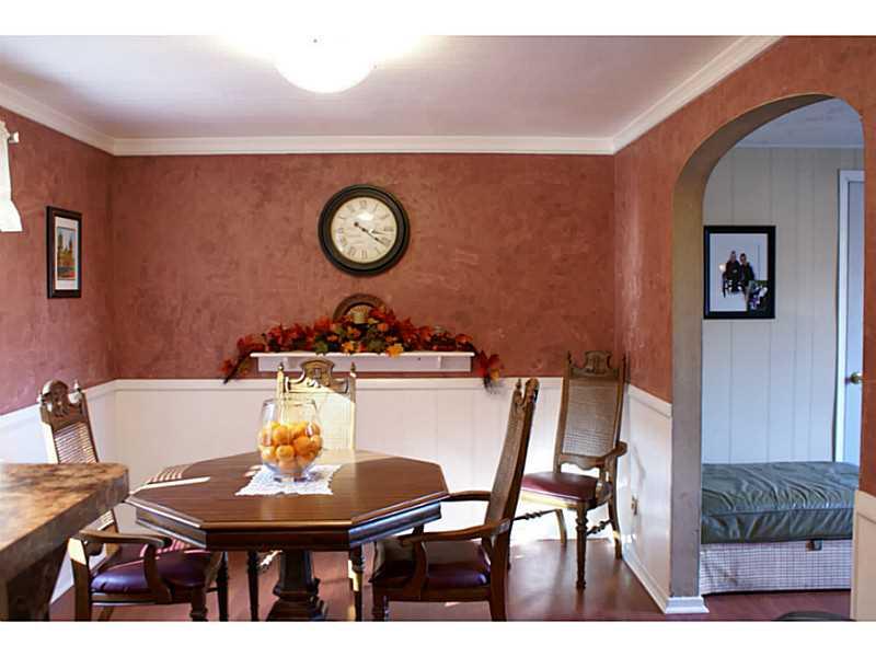 860 Middle Road Pittsburgh, PA 15234 - Photo 6 of 22 Dining Room has arched doorway leading to living room and laminate flooring.