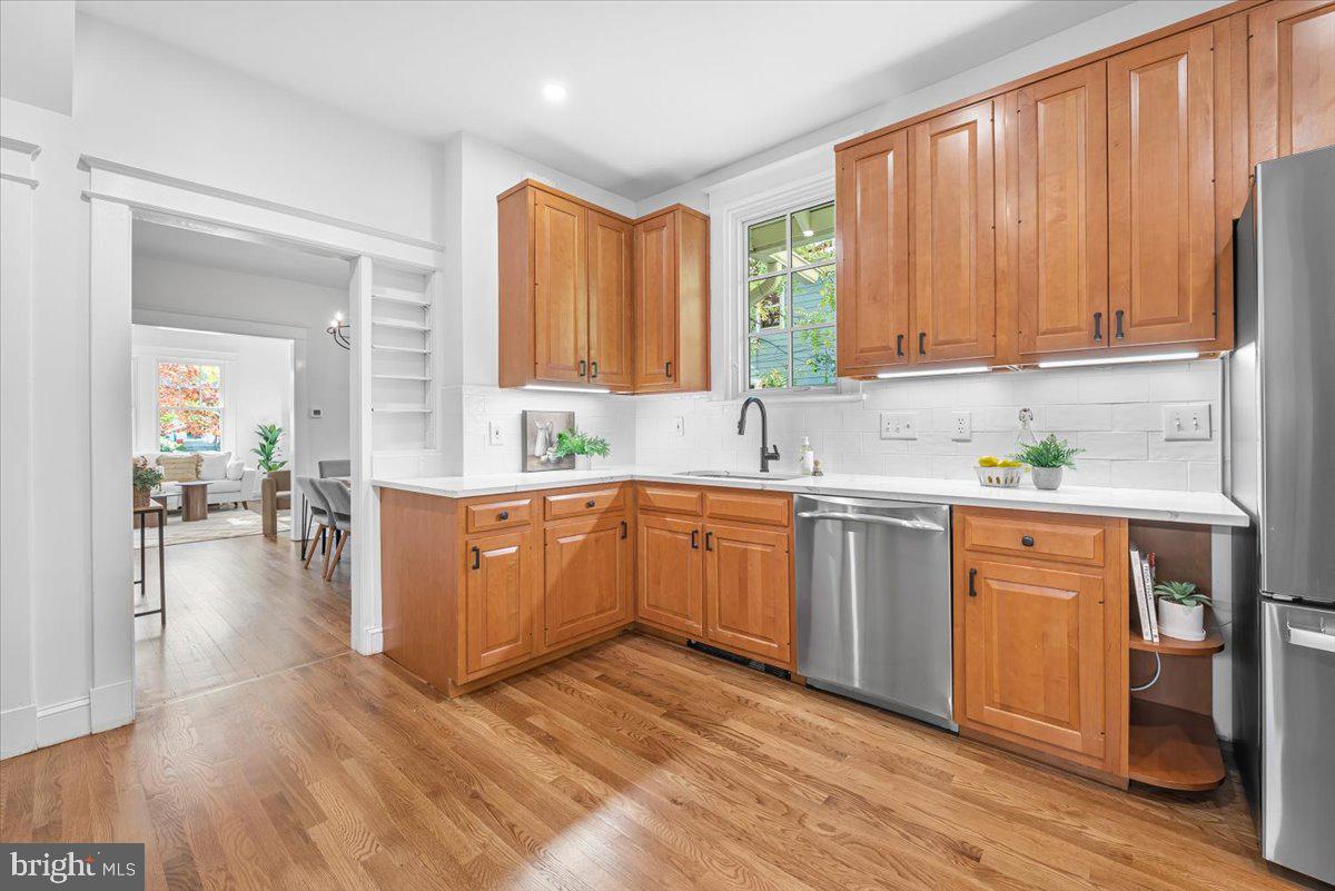 4937 Brandywine Street Northwest Washington, DC 20016 - Photo 12 of 53 a kitchen with a sink cabinets stainless steel appliances and wooden floor