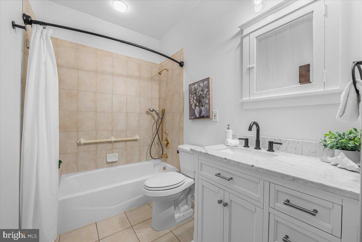 4937 Brandywine Street Northwest Washington, DC 20016 - Photo 24 of 53 a bathroom with a granite countertop sink toilet and shower