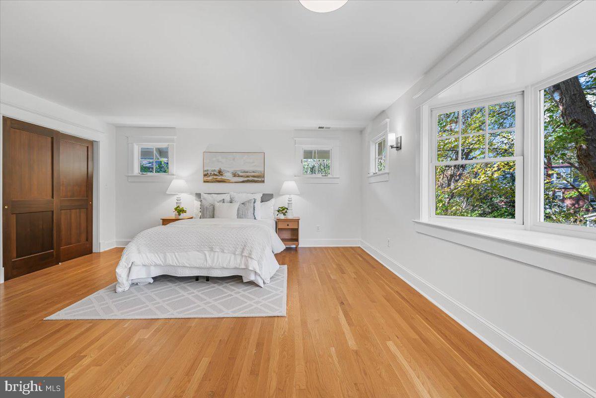 4937 Brandywine Street Northwest Washington, DC 20016 - Photo 30 of 53 a spacious bedroom with a bed and wooden floor
