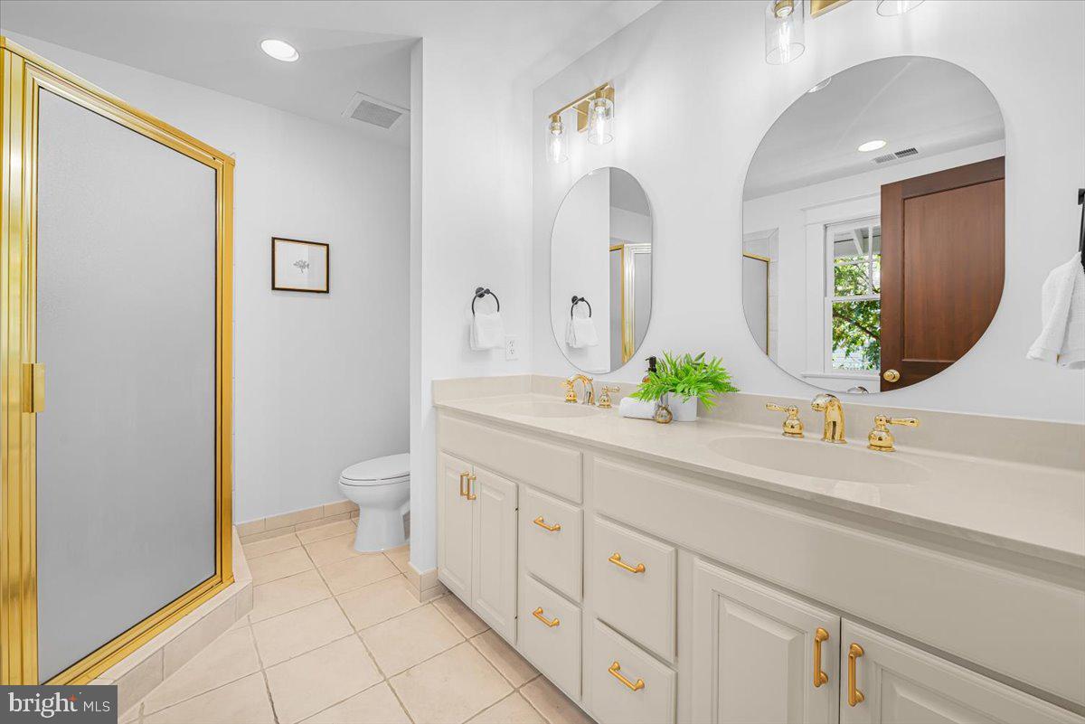 4937 Brandywine Street Northwest Washington, DC 20016 - Photo 33 of 53 a spacious bathroom with a double vanity sink mirror and toilet