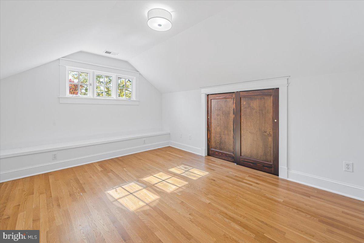 4937 Brandywine Street Northwest Washington, DC 20016 - Photo 36 of 53 an empty room with wooden floor and windows