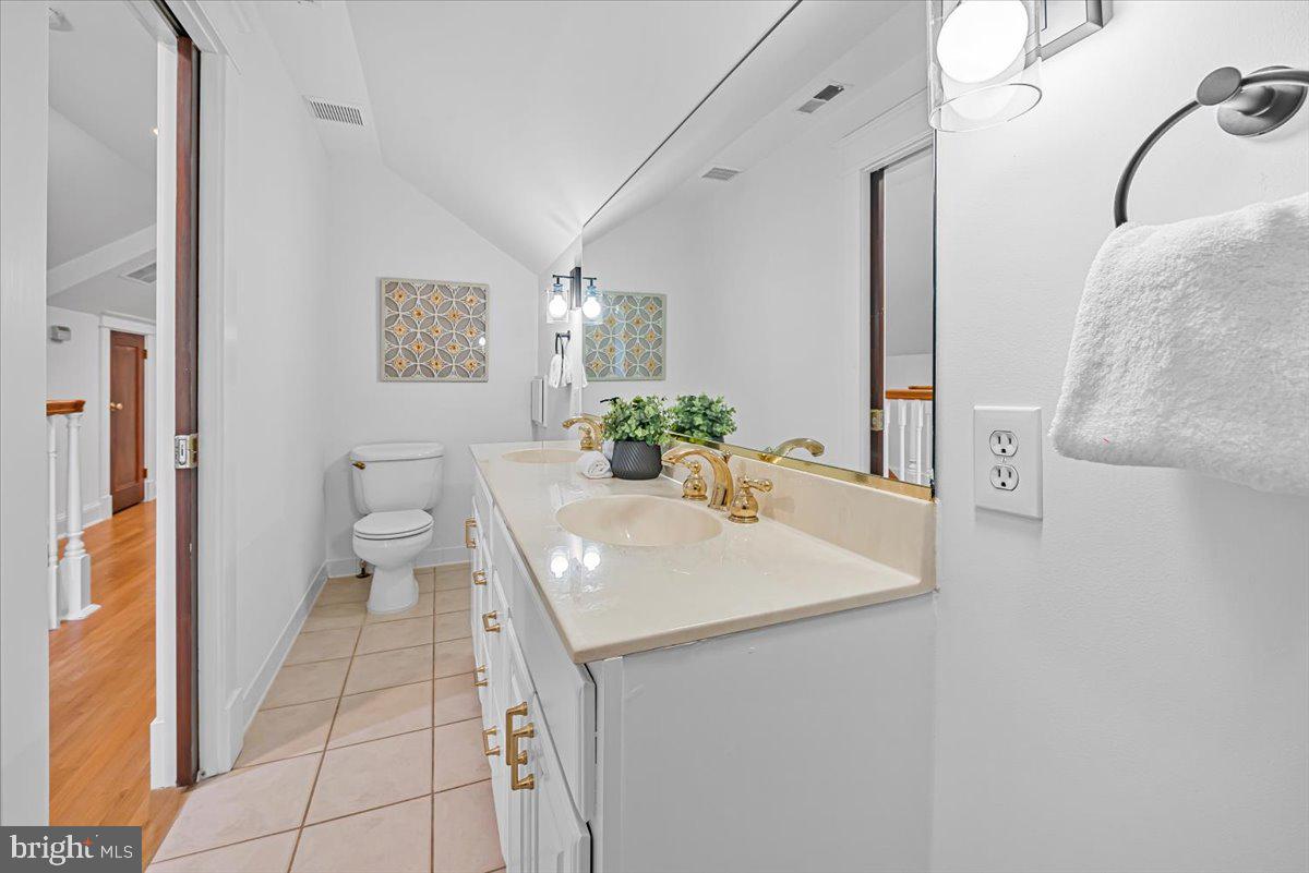 4937 Brandywine Street Northwest Washington, DC 20016 - Photo 38 of 53 a bathroom with a sink a toilet and mirror