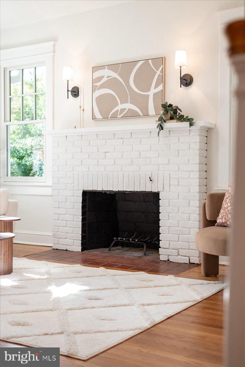 4937 Brandywine Street Northwest Washington, DC 20016 - Photo 8 of 53 a living room with a fireplace and a large window