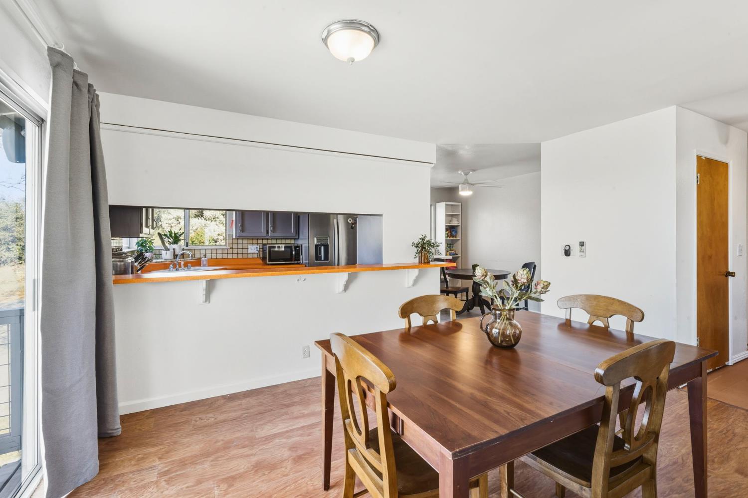 11172 North Ponderosa Way Rough and Ready, CA 95975 - Photo 14 of 47 a view of a dining room with furniture and wooden floor