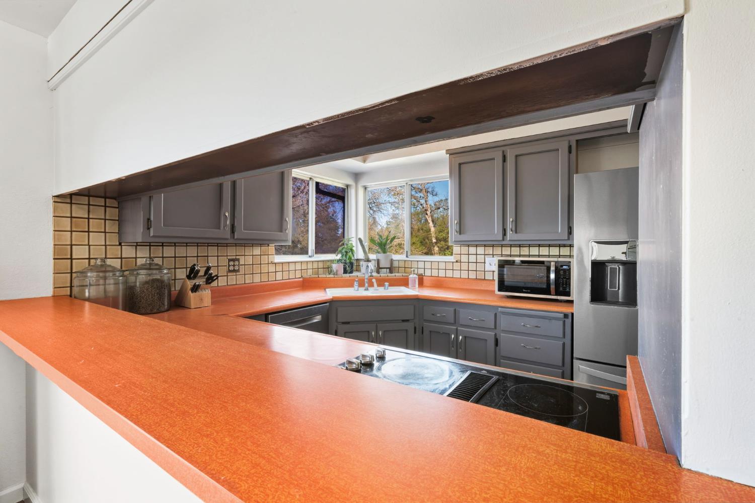 11172 North Ponderosa Way Rough and Ready, CA 95975 - Photo 15 of 47 a kitchen with stainless steel appliances kitchen island granite countertop a sink and cabinets