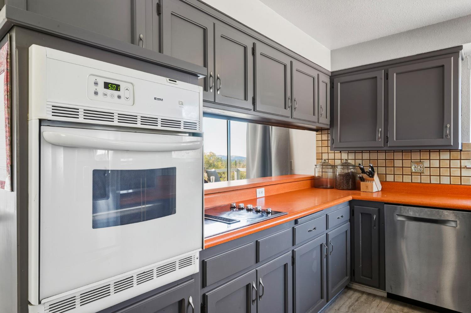 11172 North Ponderosa Way Rough and Ready, CA 95975 - Photo 17 of 47 a kitchen with stainless steel appliances granite countertop a sink stove and cabinets