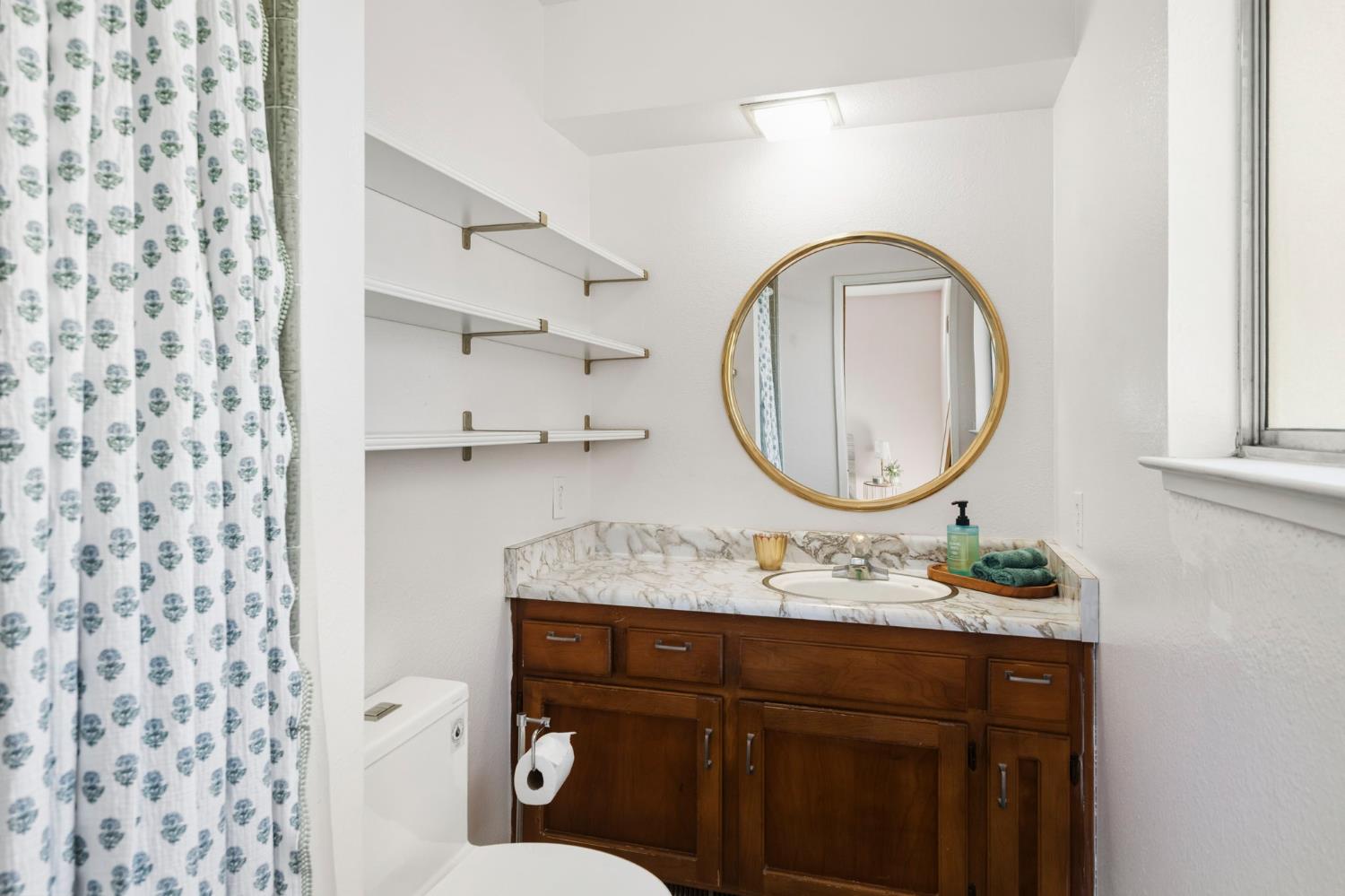 11172 North Ponderosa Way Rough and Ready, CA 95975 - Photo 22 of 47 a bathroom with a sink mirror vanity and toilet