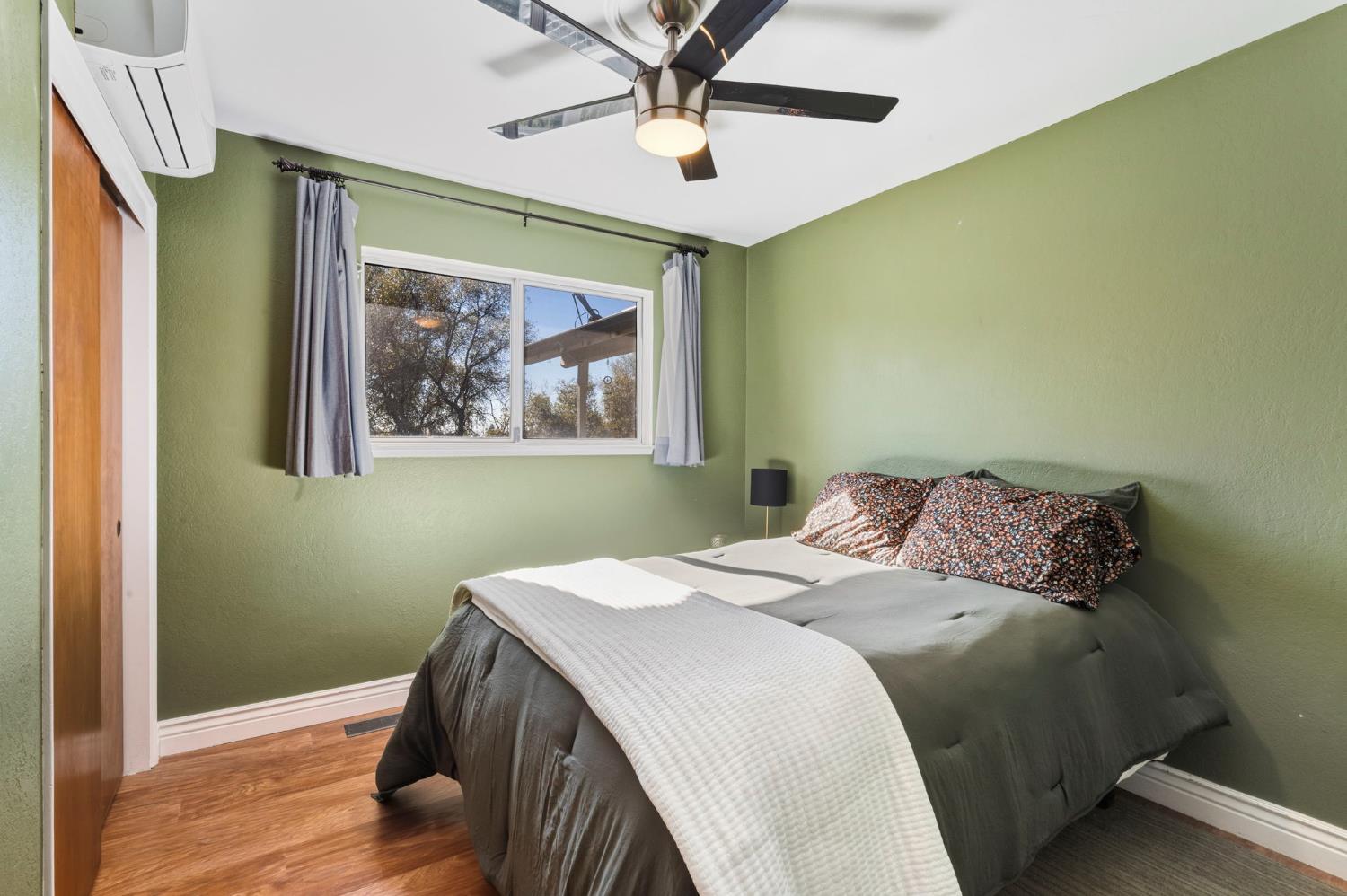 11172 North Ponderosa Way Rough and Ready, CA 95975 - Photo 24 of 47 a bedroom with a bed and a painting on the wall