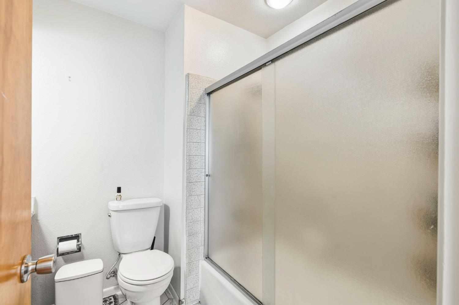 11172 North Ponderosa Way Rough and Ready, CA 95975 - Photo 27 of 47 a white toilet sitting next to a white sink and vanity