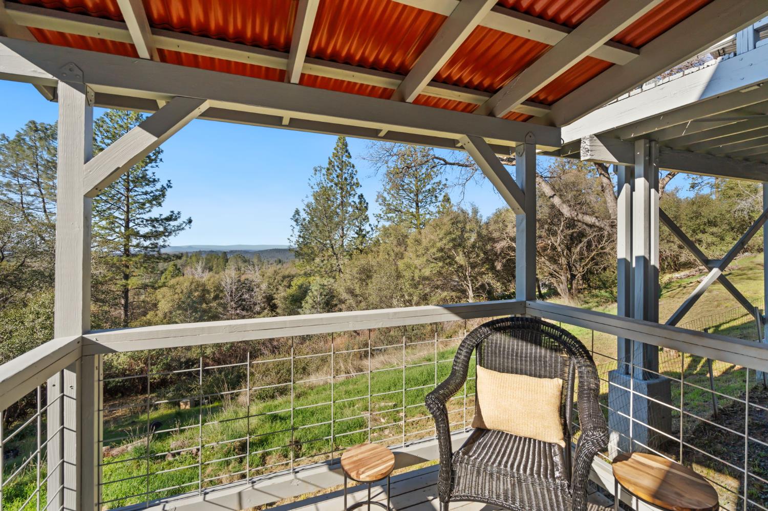 11172 North Ponderosa Way Rough and Ready, CA 95975 - Photo 33 of 47 a view of a chair and tables in the balcony