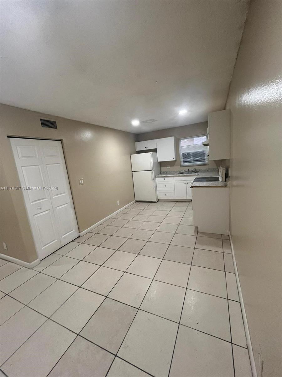 7490 Southwest 10th Court, Unit 14 North Lauderdale, FL 33068 - Photo 6 of 7 a kitchen with a sink and cabinets
