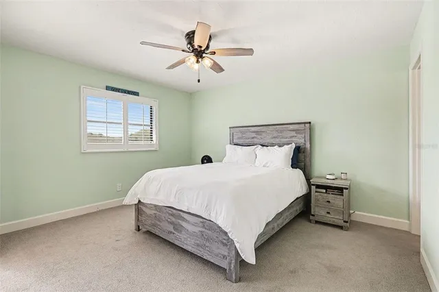 a bedroom with a bed and window