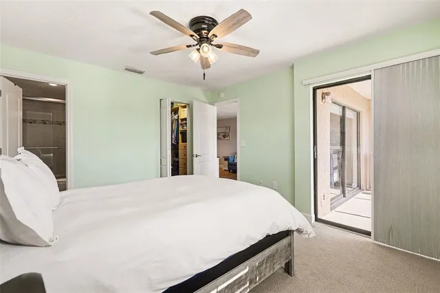 a bedroom with a large bed and a chandelier