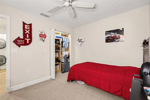 a bedroom with a bed and a book shelf