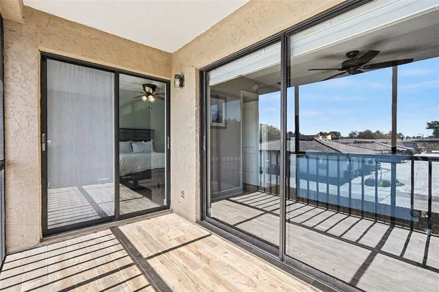 a view of a balcony with a glass door