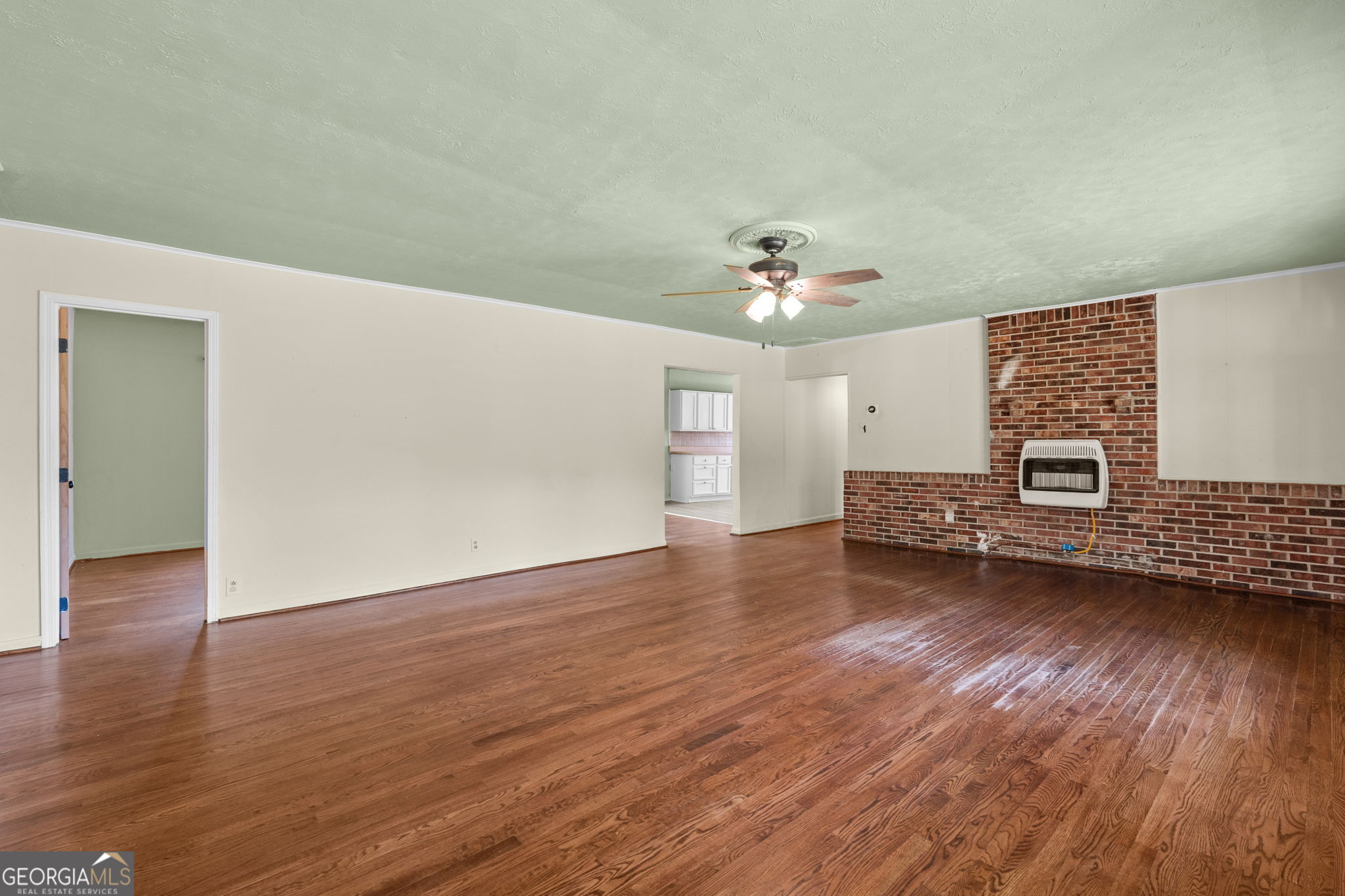49 Frost Road Bowdon, GA 30108 - Photo 10 of 60 a view of livingroom with hardwood floor and kitchen