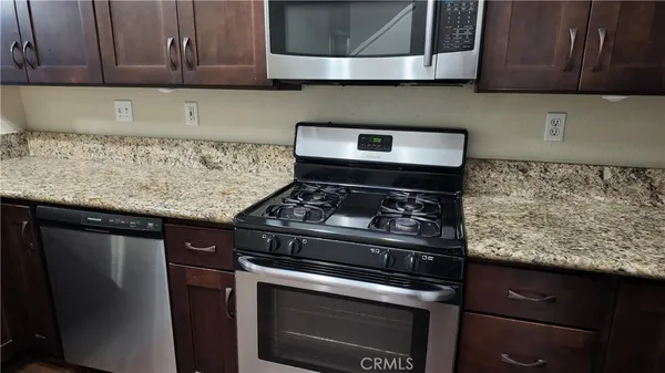 an empty room with wooden floor and mirror