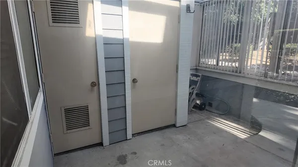 an empty room with wooden floor and fireplace
