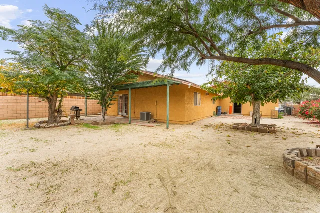 a view of a house with a patio and a tree
