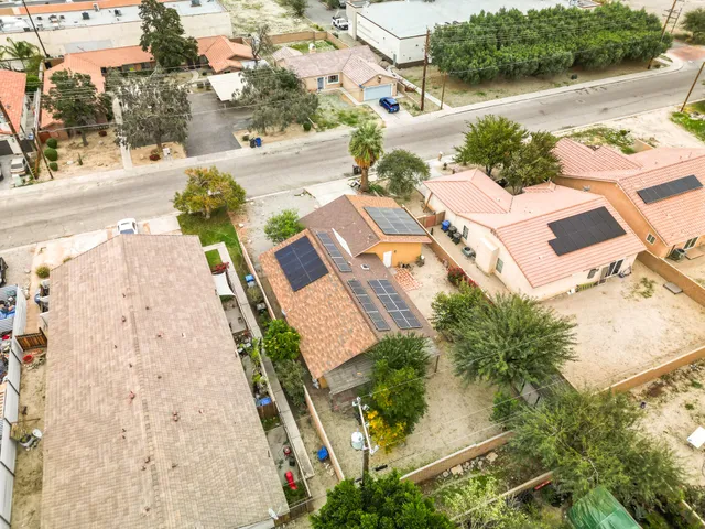 an aerial view of residential houses with outdoor space