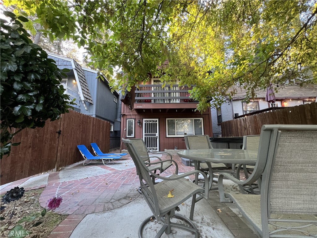 a view of a patio with table and chairs and potted plants