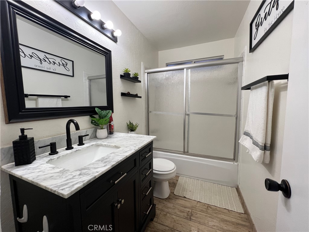 22903 Waters Crestline, CA 92325 - Photo 19 of 22 a bathroom with a granite countertop sink toilet and shower