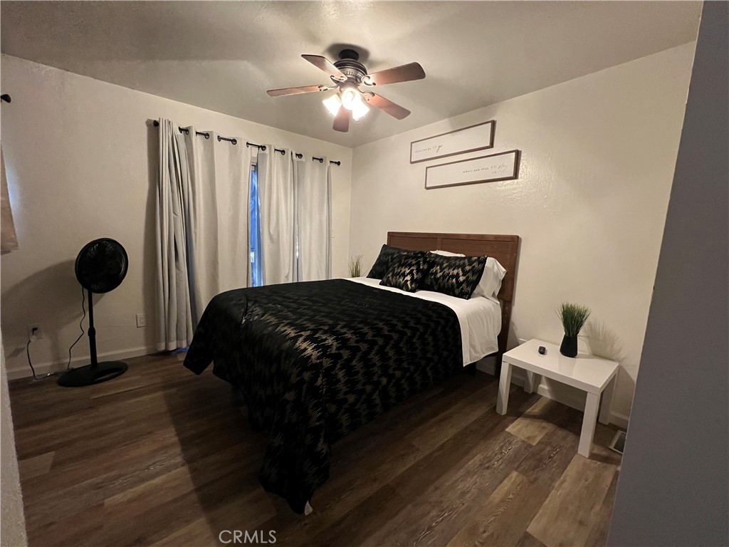 22903 Waters Crestline, CA 92325 - Photo 20 of 22 a bedroom with a bed and a chandelier