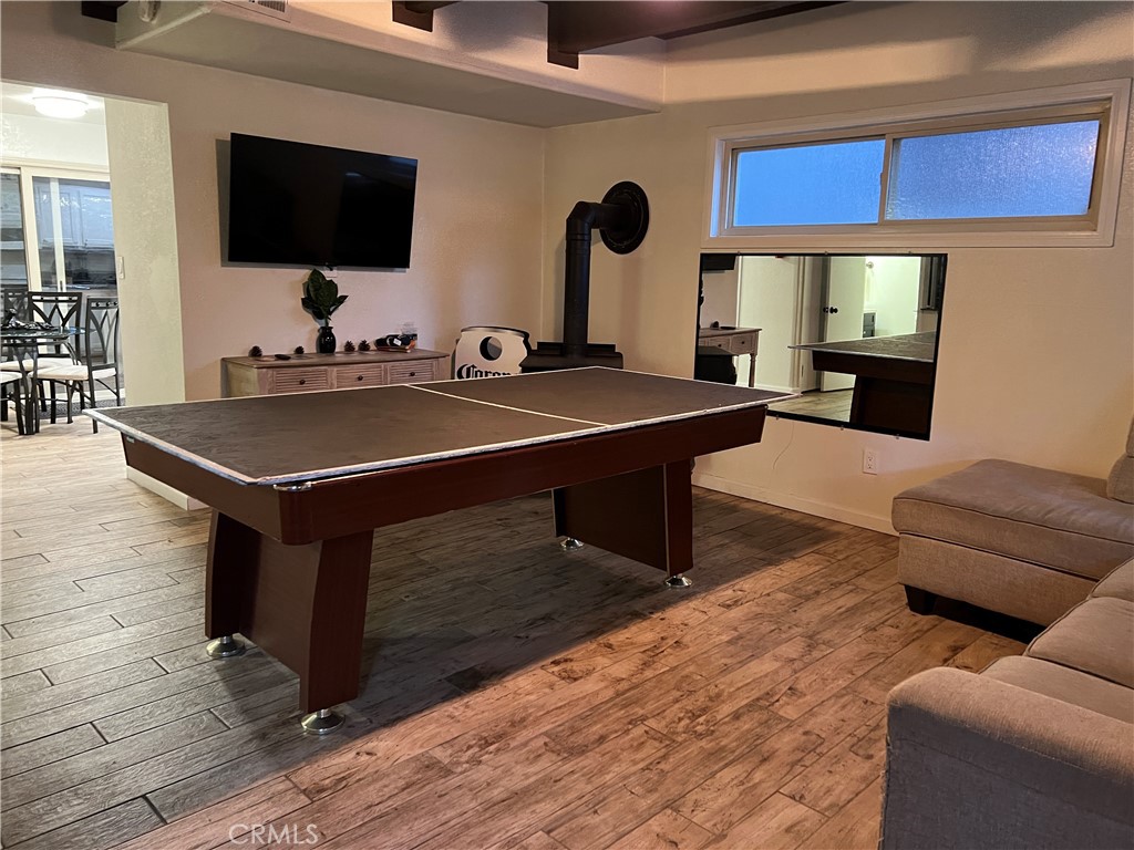 22903 Waters Crestline, CA 92325 - Photo 4 of 22 a living room with furniture a flat screen tv and kitchen view