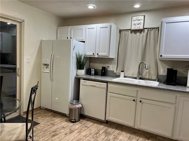 a kitchen with stainless steel appliances a refrigerator sink and cabinets