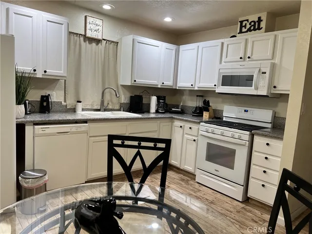 a kitchen with a stove a sink and a refrigerator