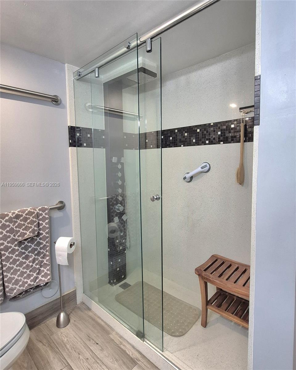 3854 Lyons Road, Unit 1025 Coconut Creek, FL 33073 - Photo 13 of 30 a bathroom with a toilet and a shower