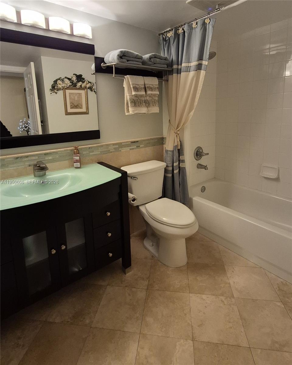 3854 Lyons Road, Unit 1025 Coconut Creek, FL 33073 - Photo 18 of 30 a bathroom with a sink a toilet and shower