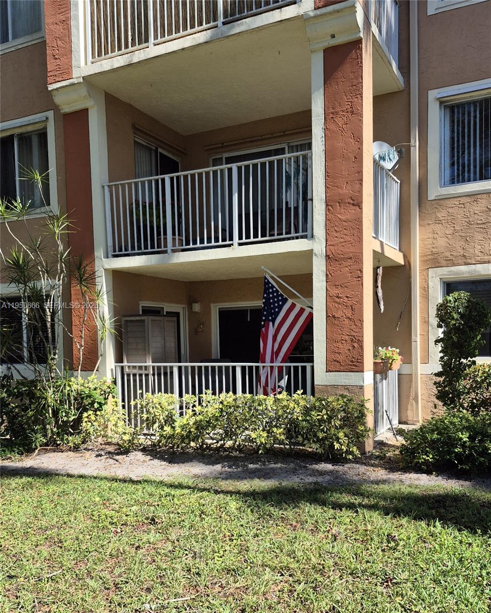 3854 Lyons Road, Unit 1025 Coconut Creek, FL 33073 - Photo 23 of 30 a front view of a house with a yard
