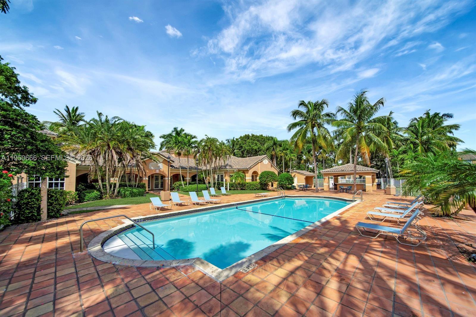 3854 Lyons Road, Unit 1025 Coconut Creek, FL 33073 - Photo 24 of 30 a view of a swimming pool with a yard