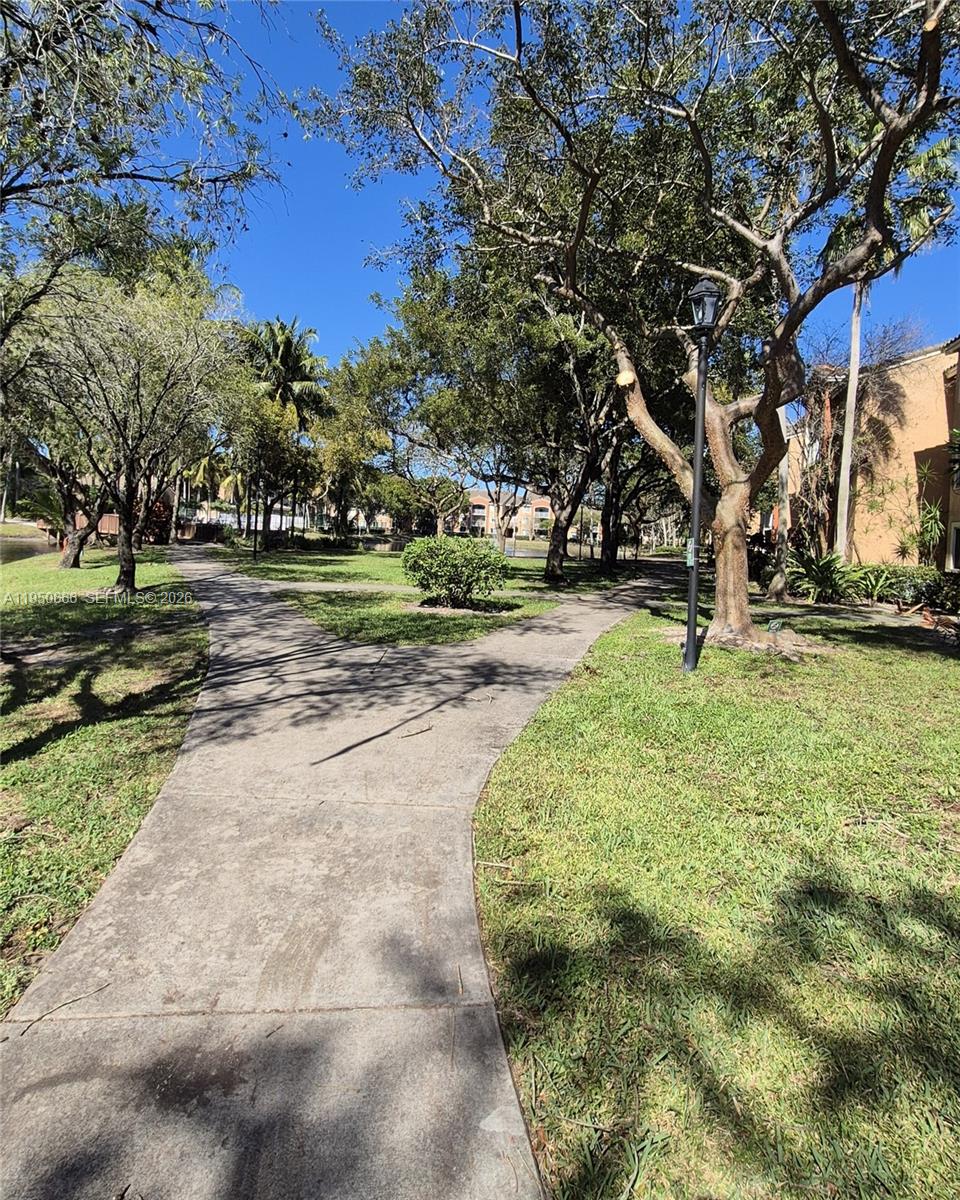 3854 Lyons Road, Unit 1025 Coconut Creek, FL 33073 - Photo 26 of 30 a backyard of a house with lots of green space