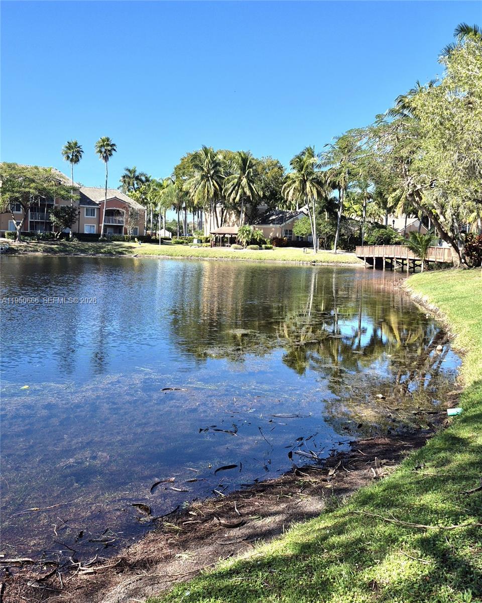 3854 Lyons Road, Unit 1025 Coconut Creek, FL 33073 - Photo 27 of 30 a view of a lake with houses