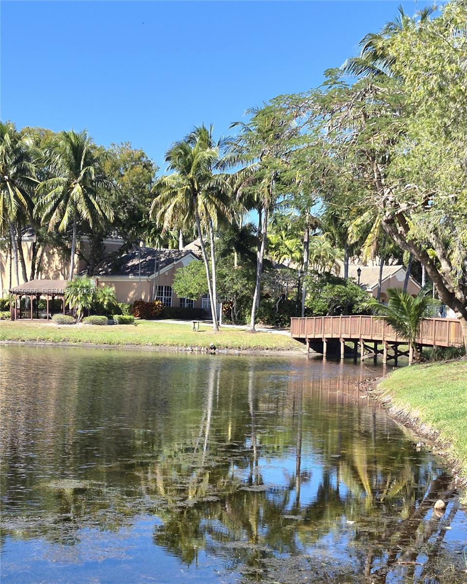 3854 Lyons Road, Unit 1025 Coconut Creek, FL 33073 - Photo 28 of 30 a view of swimming pool with outdoor seating and yard