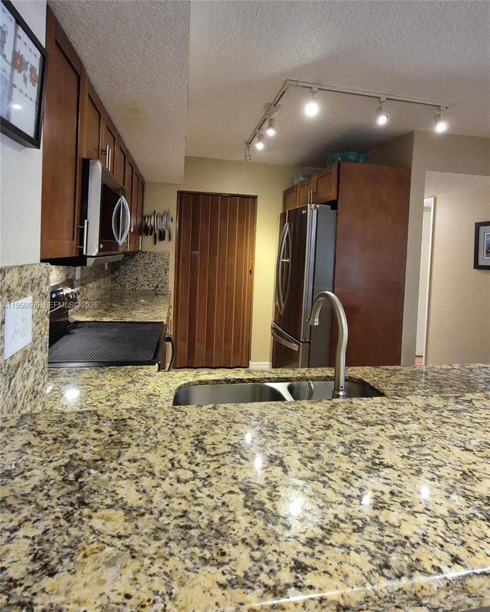 3854 Lyons Road, Unit 1025 Coconut Creek, FL 33073 - Photo 3 of 30 a view of a refrigerator in a room