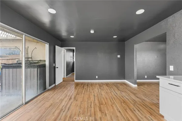 a kitchen with cabinets oven and a wooden floor