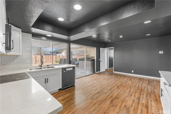 a kitchen with a refrigerator and a stove top oven
