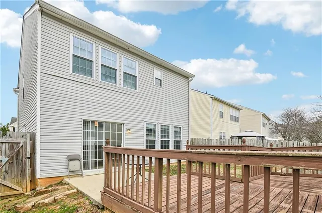 a view of a balcony with wooden floor and fence