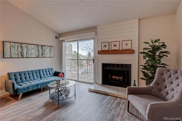 a living room with furniture a window and a fireplace