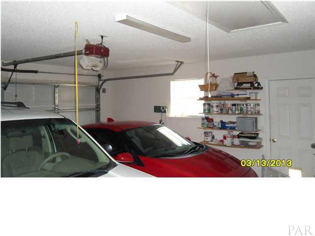 7417 Woodside Road Pensacola, FL 32526 - Photo 20 of 25 GARAGE DOOR OPENER AND PULL DOWN STAIRS TO ATTIC AND WALK DOOR TO THE OUTSIDE