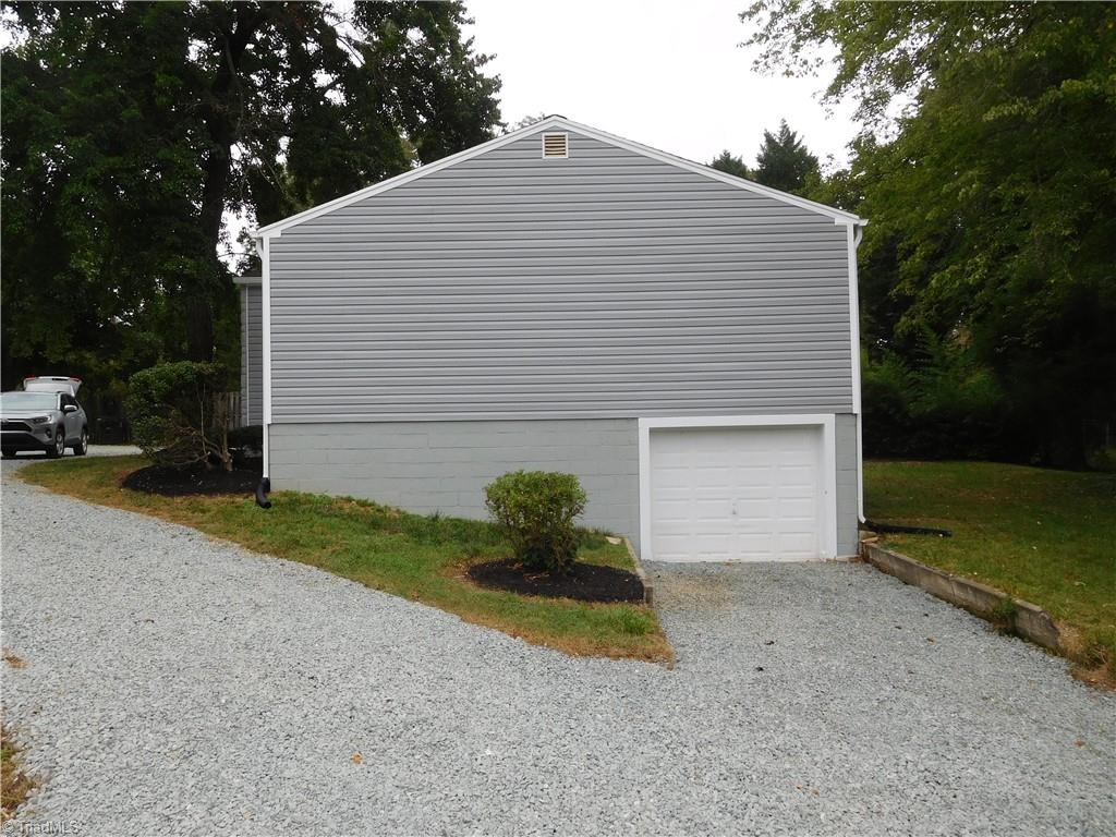 2126 Polo Road Winston-Salem, NC 27106 - Photo 29 of 33 Side View of Home and basement Garage. All New Driveway added w/fresh gravel. Plenty of turn around space.