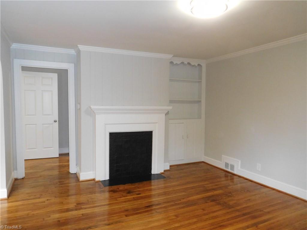 2126 Polo Road Winston-Salem, NC 27106 - Photo 4 of 33 BEAUTIFUL Hardwoods throughout home. Decorative non-functioning Fireplace (actually decorative mantle) in LR. Built in Bookshelf w/cabinet.