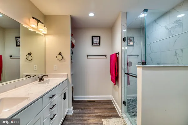 a bathroom with a sink mirror and vanity