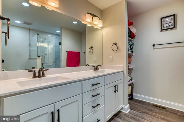 a bathroom with a double vanity sink and a mirror