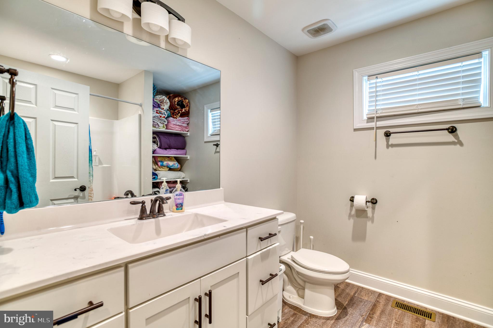 13084 Stonehouse Mountain Road Culpeper, VA 22701 - Photo 18 of 37 a bathroom with a sink a toilet and a mirror